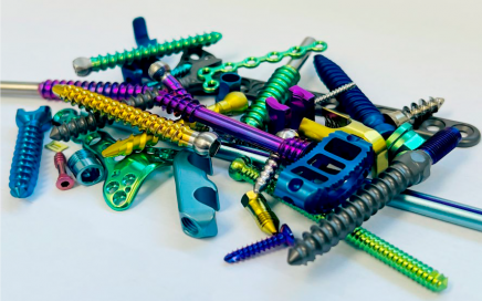 Assorted screws and other small parts anodized in various colors by Danco Medical.