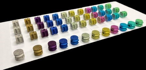 An array of Color Anodized 3D Printed Porous Products from Danco Medical.